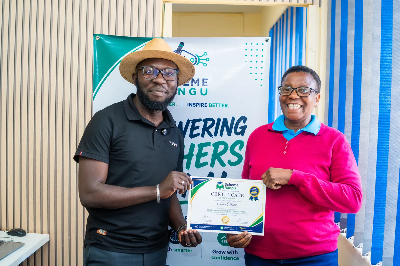 A Harare participant in a pink top receiving her workshop certificate