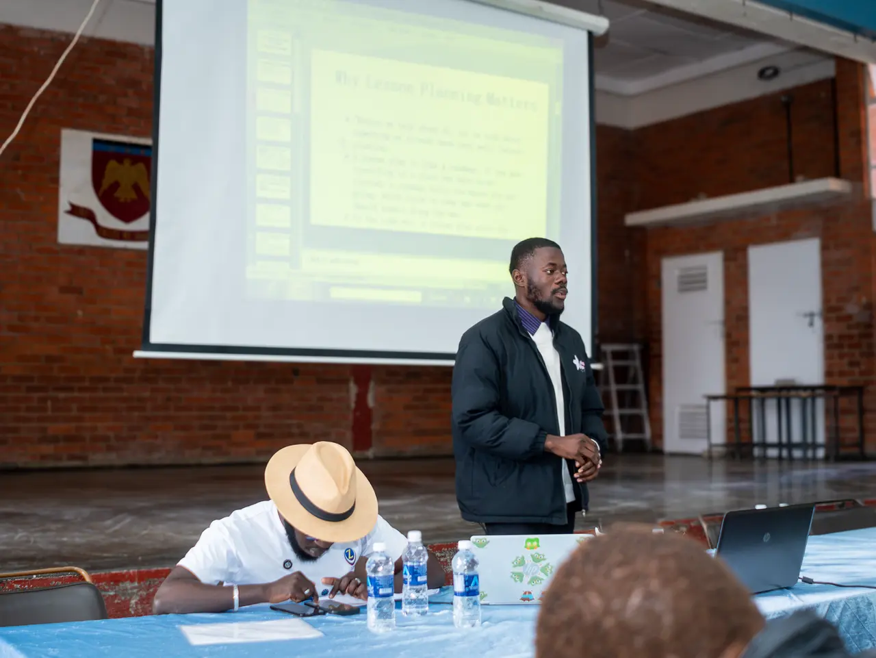 A facilitator beside laptops during a practical demonstration in Mutare